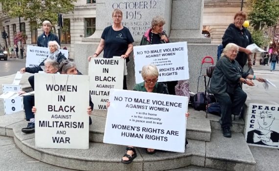 Women in Black hold placards protesting about violence against women