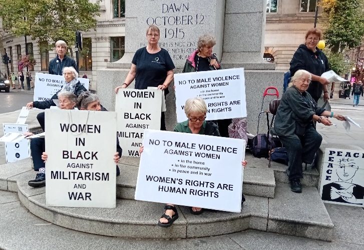 Women in Black hold placards protesting about violence against women